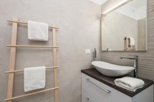 a bathroom with a sink and a mirror at Srnec Apartments - Korzo in Rijeka +38 photos
