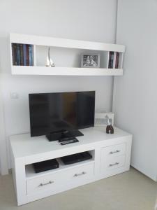 a white entertainment center with a flat screen tv at Casa Kristin (WLAN gratis) in Costa Calma