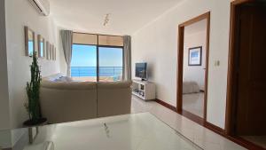 a living room with a tub and a view of the ocean at Sea View Apartment Sesimbra- Apartamento Vista Mar in Sesimbra