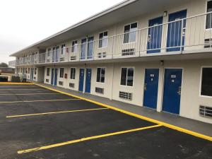 a large building with blue doors and windows at Motel 6-Alma, AR l-40 in Alma