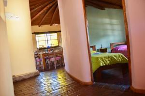 a bedroom with a bed and a dining room at misky wayra in Capilla del Monte +37 photos