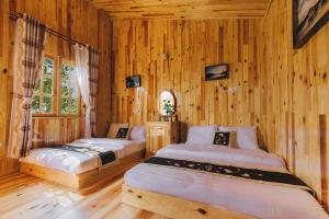 Ліжко або ліжка в номері Danh Tien Villa