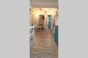 a hallway with a kitchen and a dining room at Apartman Opal in Čunski
