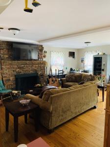 a living room with two couches and a fireplace at Stay Berkshires in Williamstown