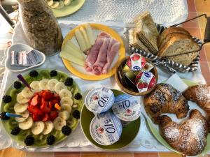 a table topped with lots of different types of food at B&B Roomantic & Piscina Idromassaggio in Cefalù