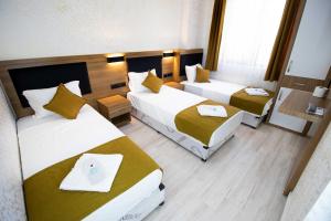a hotel room with two beds and a small room at Ersoy İkiz Otel in Antalya +35 photos