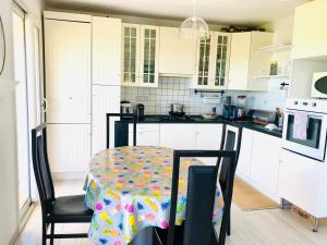 a kitchen with a table with a table cloth on it at madame LI in Cogolin