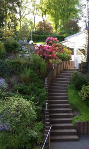 a set of stairs in a garden with flowers at Traumhafte Ferienwohnung in zentraler Lage in Bad Berleburg