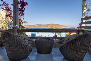 two chairs sitting on a table with a view of the ocean at Alexandros by the Beach - Serifos in Livadakia