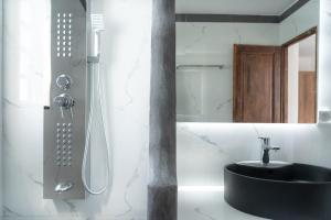 a bathroom with a black sink and a shower at Alexandros by the Beach - Serifos in Livadakia