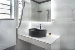 a bathroom with a black sink and a mirror at Alexandros by the Beach - Serifos in Livadakia