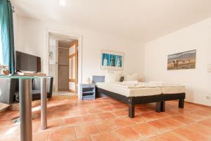 a bedroom with a bed and a flat screen tv at Ferienwohnung Hummelhus Elmenhorst in Elmenhorst