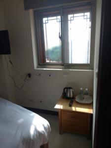 Postel nebo postele na pokoji v ubytování mei hao min su