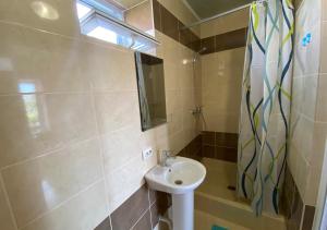 a small bathroom with a sink and a mirror at Катюша морская in Zatoka +37 photos