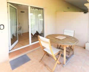 a table and chairs in a room with a patio at Orangeraie du Cap d'Antibes in Antibes