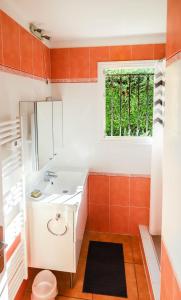 a bathroom with a white sink and a window at Orangeraie du Cap d'Antibes in Antibes