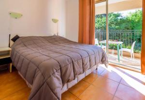 a bedroom with a bed and a large window at Orangeraie du Cap d'Antibes in Antibes