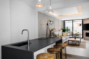 kuchnia z czarnym blatem i salon w obiekcie Malagaroom Victoria 43 w Maladze