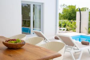 a table and chairs with a bowl of grapes on it at Villa Terra in Županje