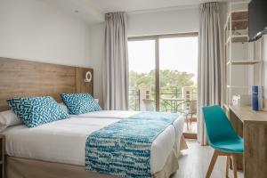 a hotel room with a bed and a balcony at Hotel Boutique Calas de Alicante in Alicante