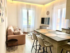 a living room with a table with chairs and a couch at ABCdecor Italia in Imperia