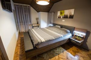 a bedroom with a large bed in a room at Holiday House Belajec in Popovača +51 photos
