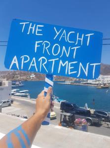 a person holding a sign that reads the yacht frontantant at Yacht front apartment - Νο 2 in Ios Chora