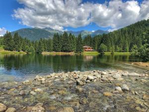 a lake with a house in the middle of it at CASA MATTEOTTI Mezzana Trentino in Mezzana