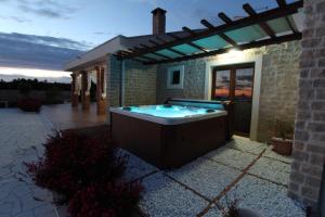 a hot tub in the backyard of a house at Villa Melody Novalja in Novalja