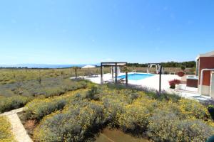 a villa with a swimming pool in a field at Villa Melody Novalja in Novalja