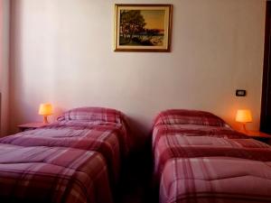 En eller flere senge i et værelse på La casa di Giosuè