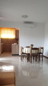 a kitchen with a table and chairs in a room at Apartman Lena in Pula