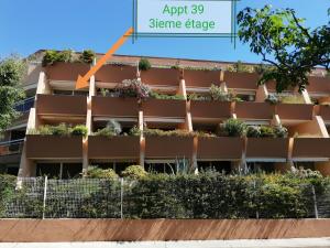 an image of an apartment building with a plant at La Calypso in Cavalaire-sur-Mer