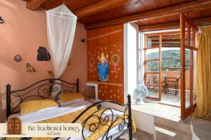 a bedroom with a bed in a room with a window at Elounda Collection Villa in Vrouchas