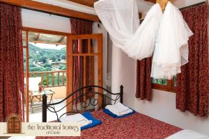 a bedroom with a bed and a window with a view at Elounda Collection Villa in Vrouchas