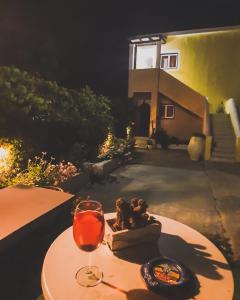 a table with a wine glass and a plate of food at Chrysanthi Melitsa apts. in Sidari