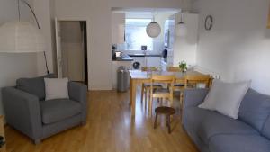 a living room with a couch and a table and chairs at Totters townhouse in Caernarfon