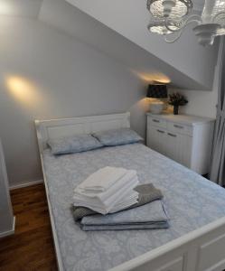 a bedroom with a bed with towels on it at Black Valley House in Gura Humorului