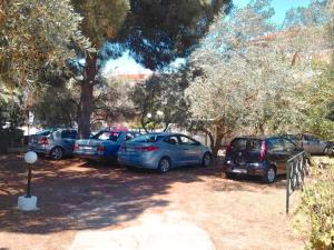 a group of cars parked in a parking lot at Penny's Holiday Studio in Hanioti