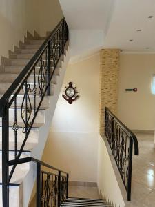 a staircase in a house with a clock on the wall at Міні-готель "Кімната Комфорт" in Odesa