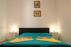 a bedroom with a bed with two towels on it at Cycladic houses in rural surrounding 3 in Tholária