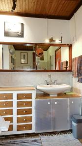 a bathroom with a sink and a mirror at The old olive mill house in Aegae