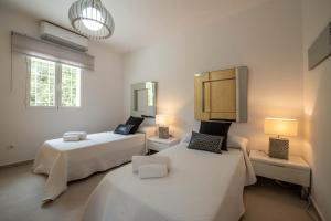 pokój z 2 łóżkami i 2 lampami w obiekcie Can Garchet White Ibiza w mieście Sant Jordi