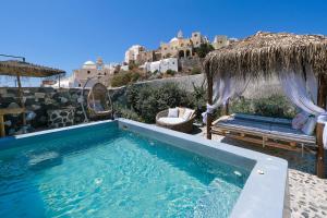 a swimming pool with a view of a building at Rock Villas - Complex in Emporio Santorini