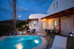 a villa with a swimming pool in front of a house at Villa Haritomeni in Parikia