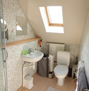 a bathroom with a white toilet and a sink at Be.Cosy in Brussels