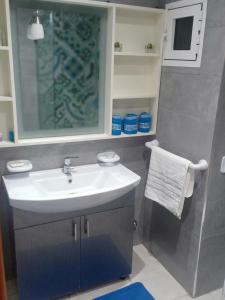 a bathroom with a sink and a mirror at Appartement plage mehdia in Kenitra