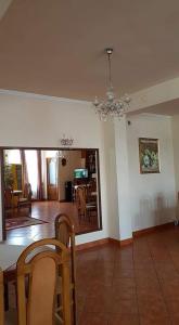 a dining room and living room with a chandelier at Pensiunea Clasic in Gherla