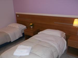 Postel nebo postele na pokoji v ubytování Albergo Meublè Abatjour