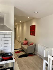 a living room with a couch and a kitchen at Plymouth Hoe Hideaway in Plymouth